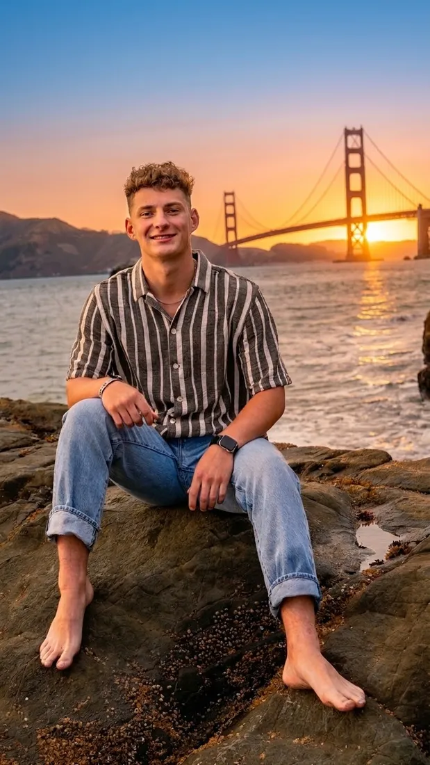 Senior portrait on the rocks at sunset